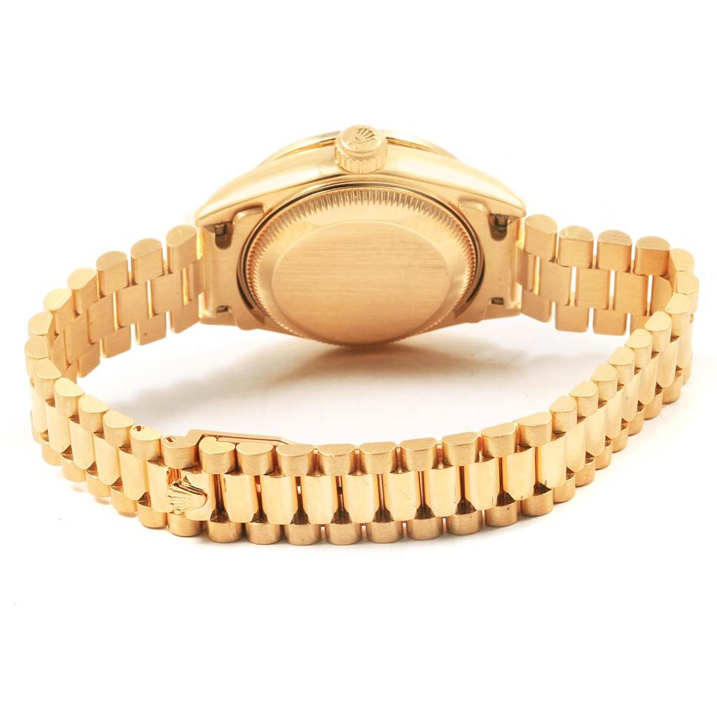 The image shows a Rolex President 79138 Women's Yellow Gold Mother of Pearl Dial 79138 Women's Yellow Gold Mother of Pearl Dial model watch from the back, highlighting the case back and the gold bracelet.