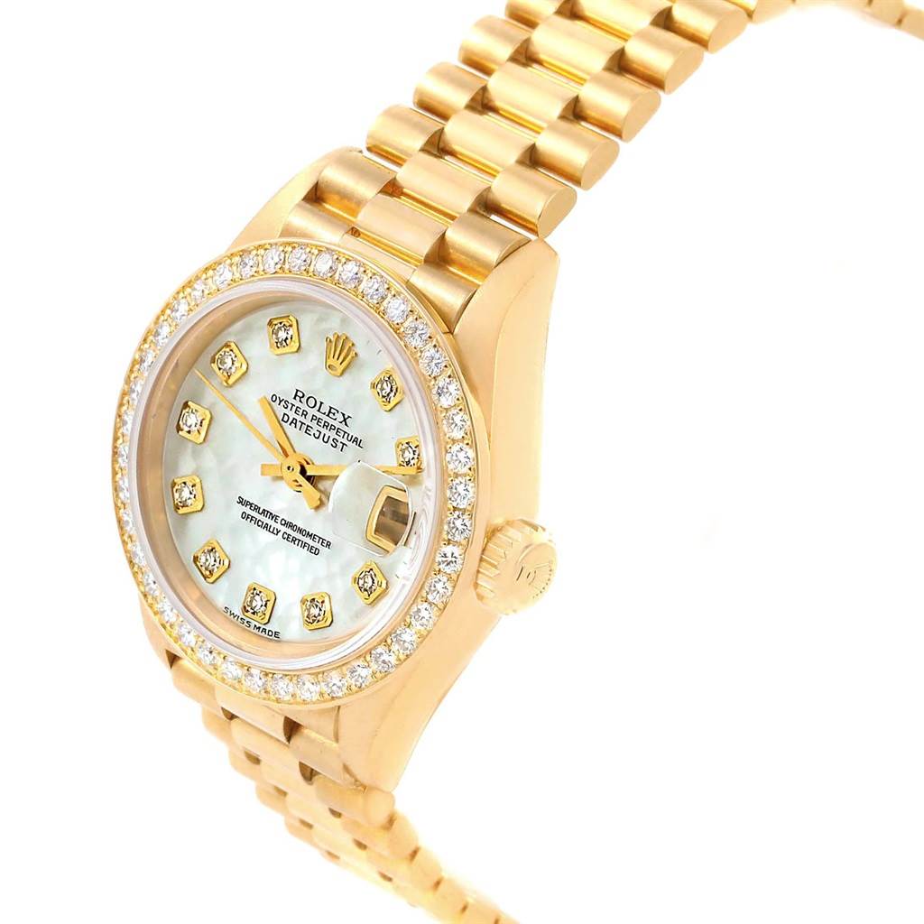The image shows a Rolex President 79138 Women's Yellow Gold Mother of Pearl Dial 79138 Women's Yellow Gold Mother of Pearl Dial model watch from an angled view, highlighting its gold bracelet, diamond bezel, and date feature.
