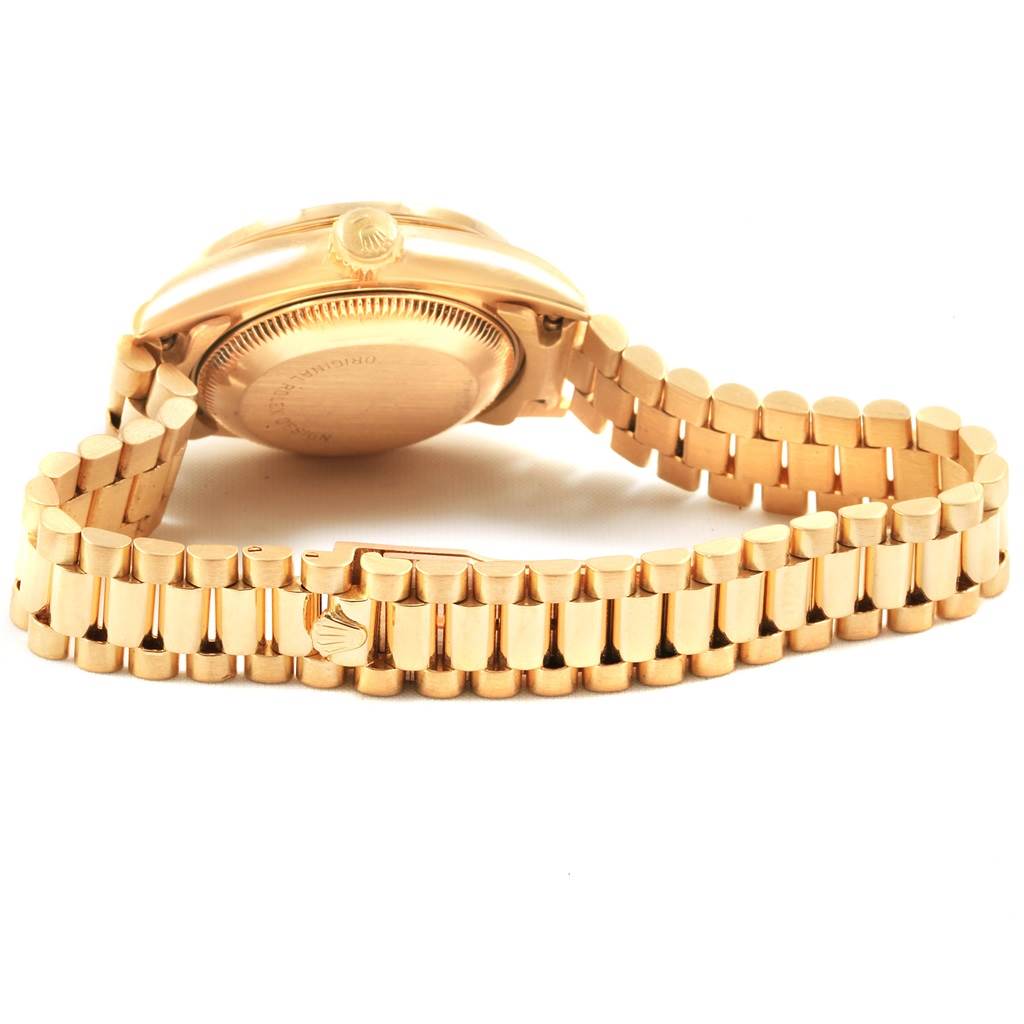 This image shows the side and back of a Rolex President 69178 Women
s Yellow Gold Champagne Dial 69178 Women
s Yellow Gold Champagne Dial watch, with a focus on the band and case back.