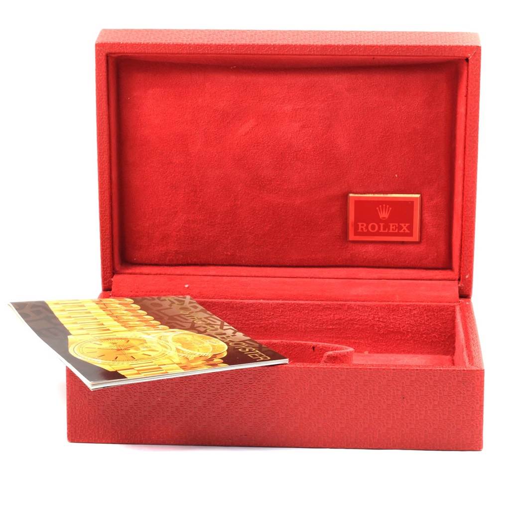 The image shows an open red Rolex box, likely for a President model watch, along with its booklet.