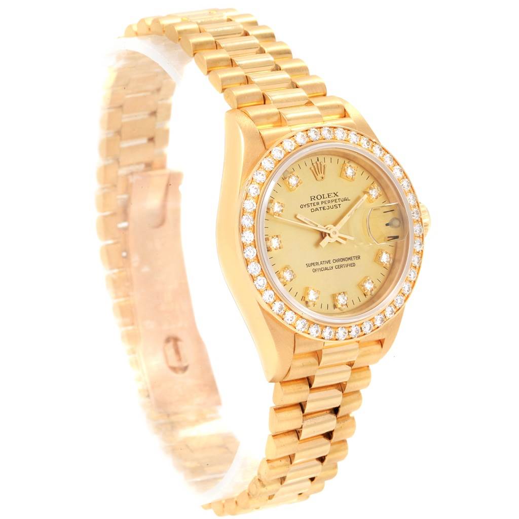 This image shows a gold Rolex President 69178 Women
s Yellow Gold Champagne Dial 69178 Women
s Yellow Gold Champagne Dial model watch with a diamond bezel, viewed at an angled perspective, showcasing the watch face and bracelet.