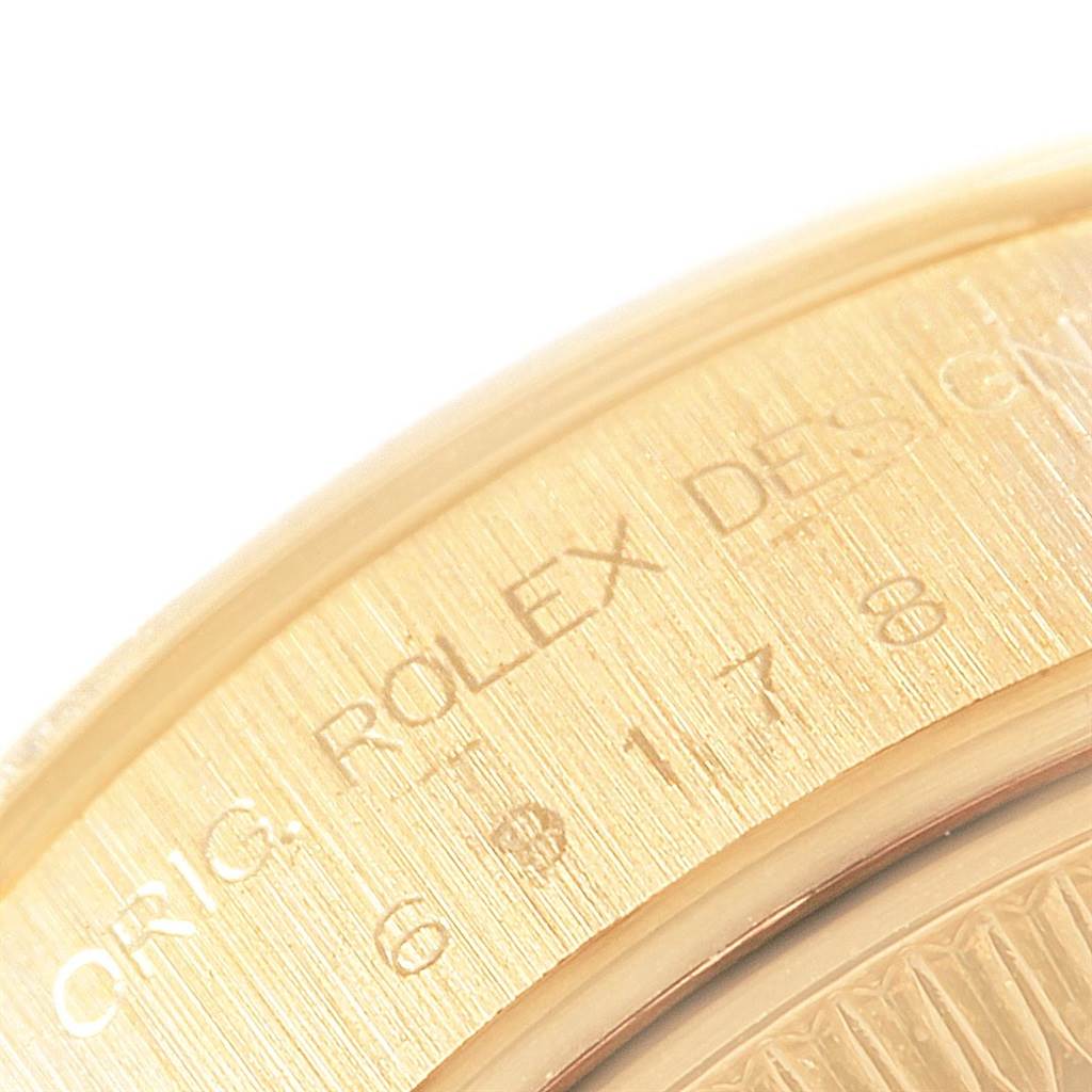 This close-up image shows part of the engraved bezel on a Rolex President 69178 Women
s Yellow Gold Champagne Dial 69178 Women
s Yellow Gold Champagne Dial model watch.
