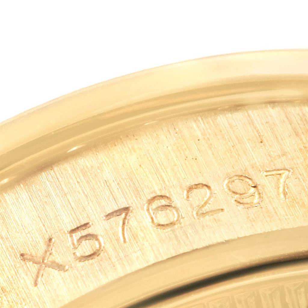The image shows a close-up of the serial number engraved on the metal caseback of a Rolex President 69158 Women's Yellow Gold Silver Dial 69158 Women's Yellow Gold Silver Dial model watch.