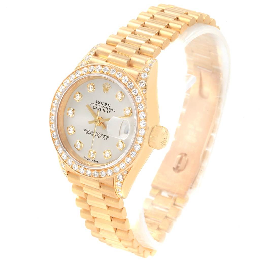 The image shows a Rolex President 69158 Women's Yellow Gold Silver Dial 69158 Women's Yellow Gold Silver Dial model watch angled to display the dial, bezel, and part of the bracelet.
