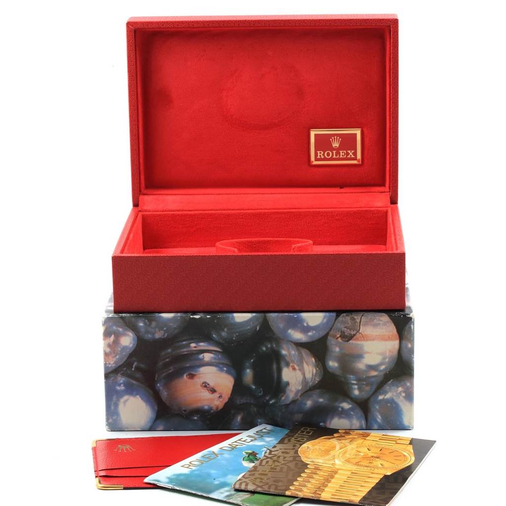 The photo shows an empty Rolex President 69158 Women's Yellow Gold Silver Dial 69158 Women's Yellow Gold Silver Dial watch box, with booklets and accessories placed in front of it.