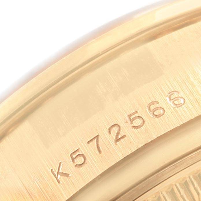 This close-up image shows the serial number engraving on the gold case back of a Rolex President 179138 Women's Yellow Gold Silver Dial 179138 Women's Yellow Gold Silver Dial model watch.