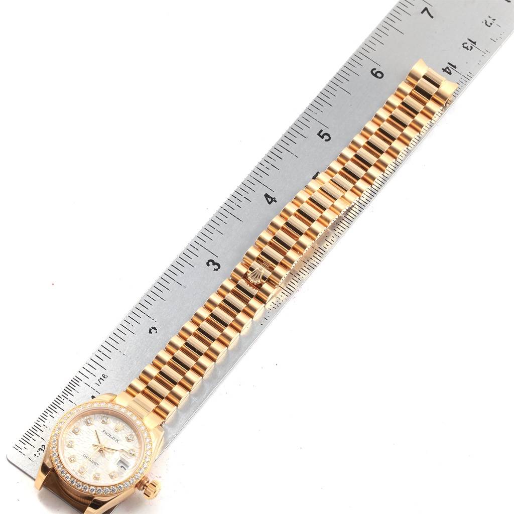 This image shows a Rolex President 179138 Women's Yellow Gold Silver Dial 179138 Women's Yellow Gold Silver Dial model watch placed alongside a ruler, highlighting its bracelet and partial face.