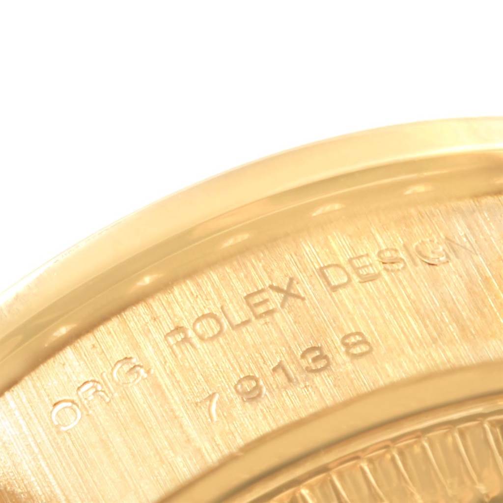 This image shows a close-up of the case back of a Rolex President 79138 Women's Yellow Gold Champagne Dial 79138 Women's Yellow Gold Champagne Dial watch, highlighting the engraved model and design details.
