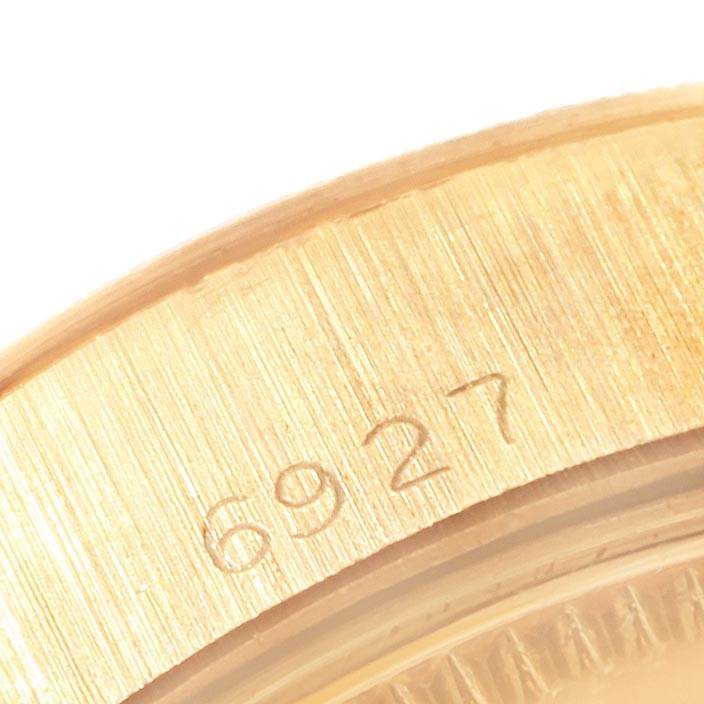 The image shows a close-up of a partial case with the model number "6927" engraved on a Rolex President 6927 Women's Yellow Gold Champagne Dial 6927 Women's Yellow Gold Champagne Dial watch.