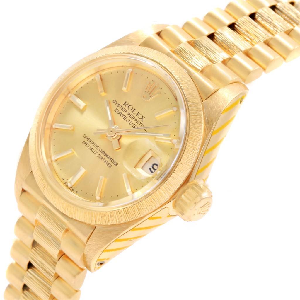 The image shows a side angle of a Rolex President 6927 Women's Yellow Gold Champagne Dial 6927 Women's Yellow Gold Champagne Dial model watch, highlighting the gold dial, bezel, crown, and bracelet.