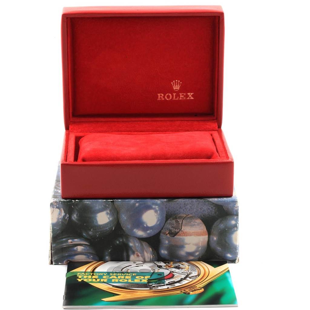 The image shows an open Rolex President 6927 Women's Yellow Gold Champagne Dial 6927 Women's Yellow Gold Champagne Dial watch box with a manual and cushion from a front-facing angle.