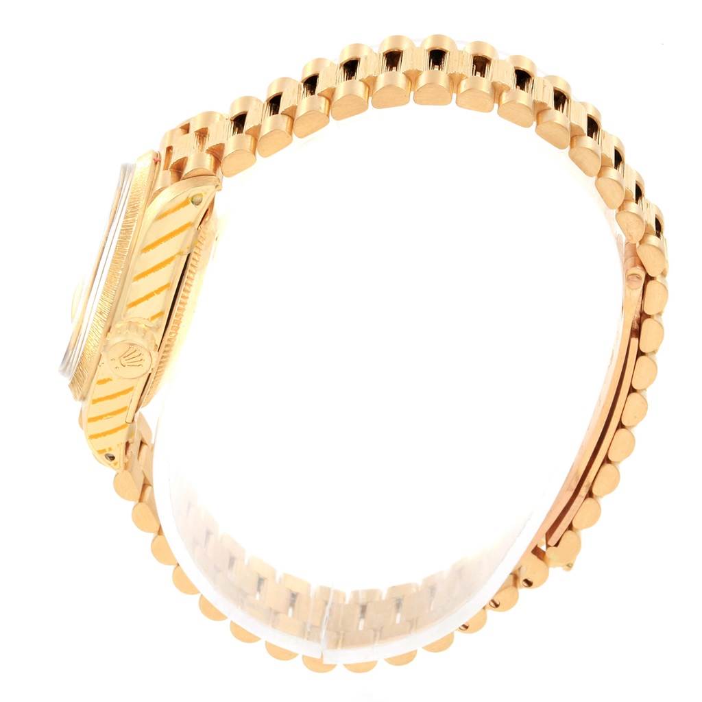 The image shows a side view of a Rolex President 6927 Women's Yellow Gold Champagne Dial 6927 Women's Yellow Gold Champagne Dial model watch, highlighting its gold case and bracelet.