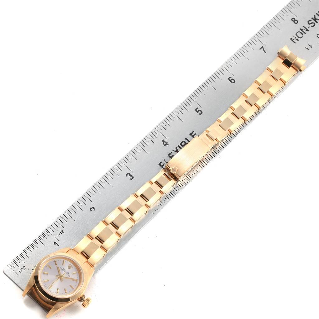 The image shows a Rolex President 67188 Women's Yellow Gold Silver Dial 67188 Women's Yellow Gold Silver Dial model watch from a top-down angle, highlighting its band and face next to a ruler.