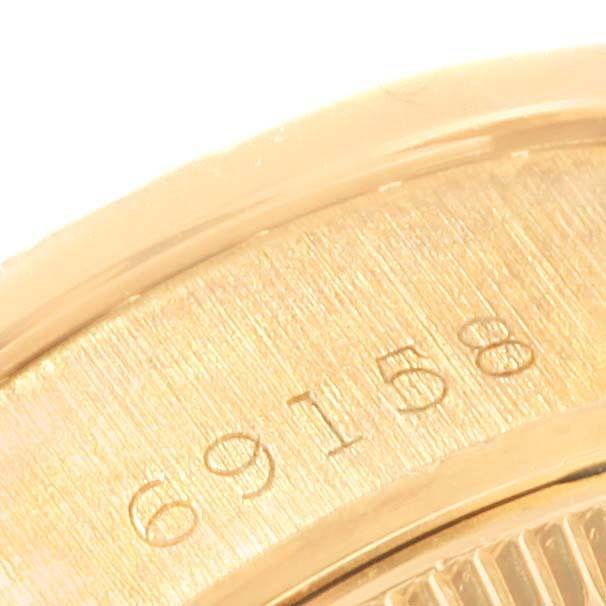 This is a close-up of the serial number 69158 on the gold case of a Rolex President 69158 Women's Yellow Gold Blue Dial 69158 Women's Yellow Gold Blue Dial model watch.