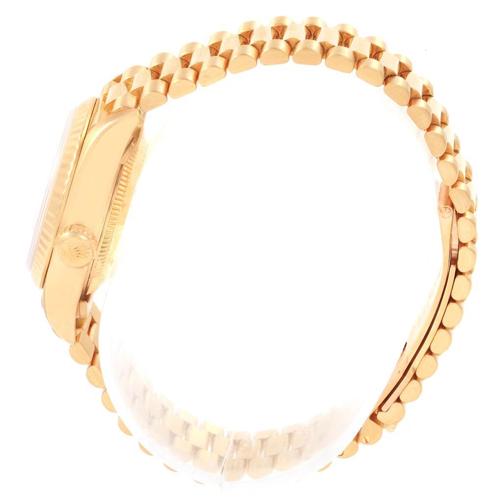 The image shows a Rolex President 69178 Women
s Yellow Gold Mother of Pearl Dial 69178 Women
s Yellow Gold Mother of Pearl Dial model watch from a side angle, highlighting the crown and part of the bracelet.