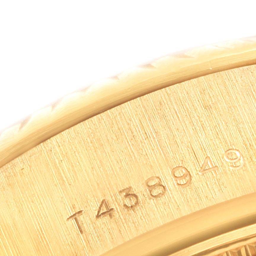 This close-up image shows a portion of the gold case with an engraved serial number on a Rolex President 69178 Women
s Yellow Gold Mother of Pearl Dial 69178 Women
s Yellow Gold Mother of Pearl Dial model watch.