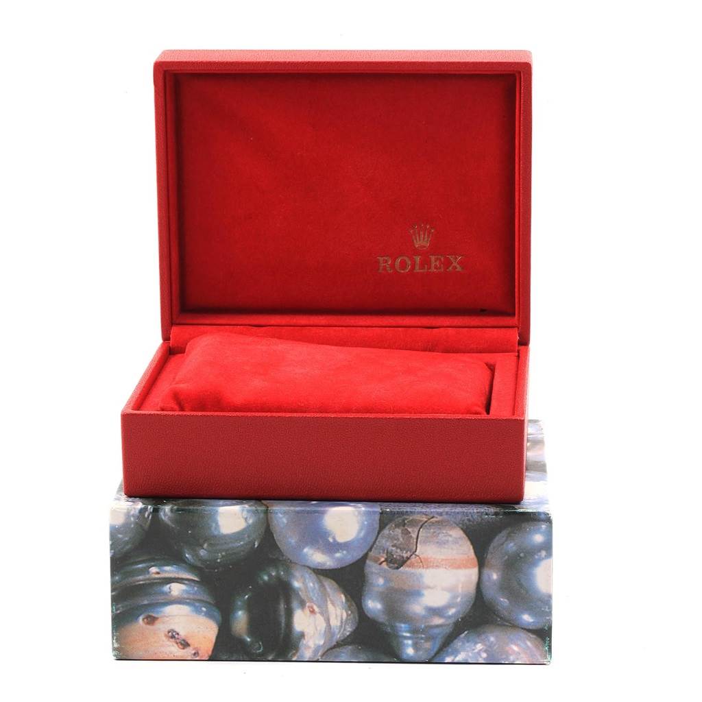 This is a red Rolex President 69178 Women
s Yellow Gold Mother of Pearl Dial 69178 Women
s Yellow Gold Mother of Pearl Dial watch box, shown open, with the interior branded and a cushion inside.
