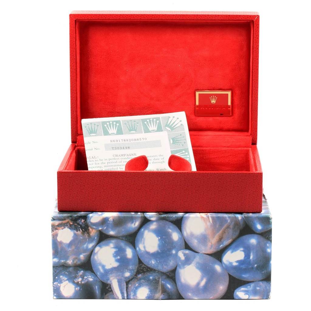 This image shows a red Rolex President 69178 Women
s Yellow Gold Champagne Dial 69178 Women
s Yellow Gold Champagne Dial model watch box and warranty card viewed from the front.