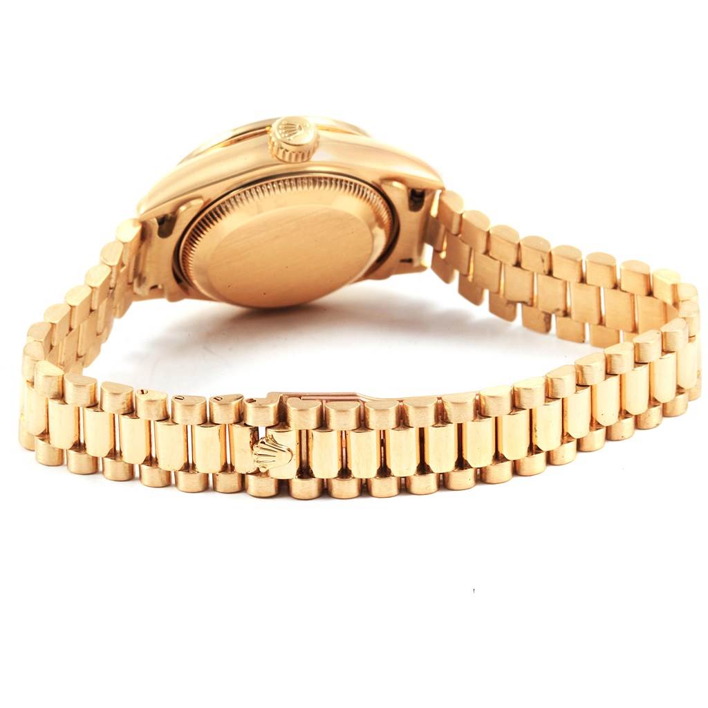 The image shows the back and side of a Rolex President 79138 Women's Yellow Gold Champagne Dial 79138 Women's Yellow Gold Champagne Dial model watch, highlighting its gold case and bracelet.