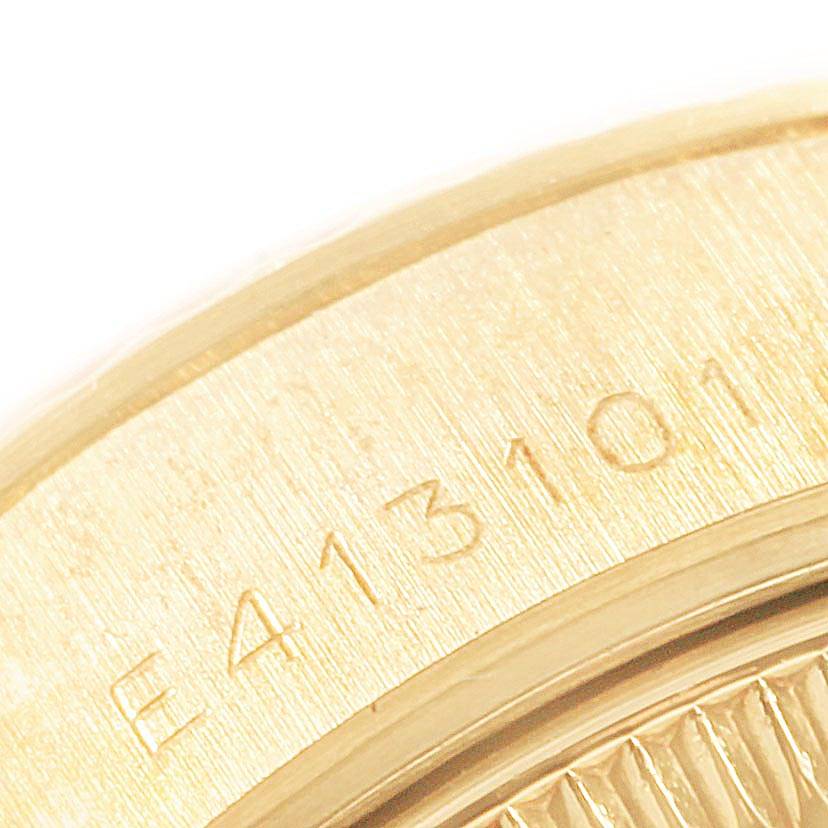 This close-up image shows the engraved serial number on the gold case of a Rolex President 69178 Women's Yellow Gold Champagne Dial 69178 Women's Yellow Gold Champagne Dial model watch.