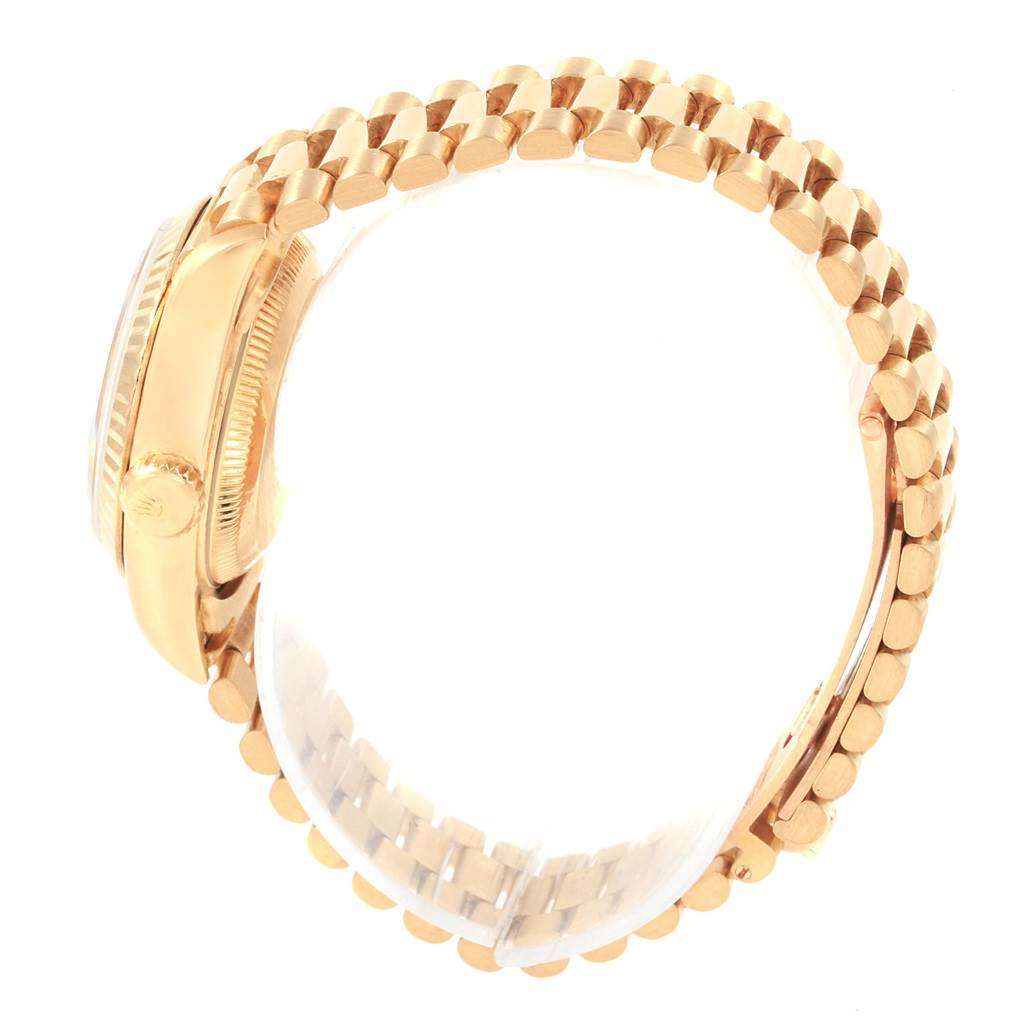 The image shows a Rolex President 69178 Women's Yellow Gold White Dial 69178 Women's Yellow Gold White Dial model wristwatch from the side, highlighting its crown and gold bracelet.