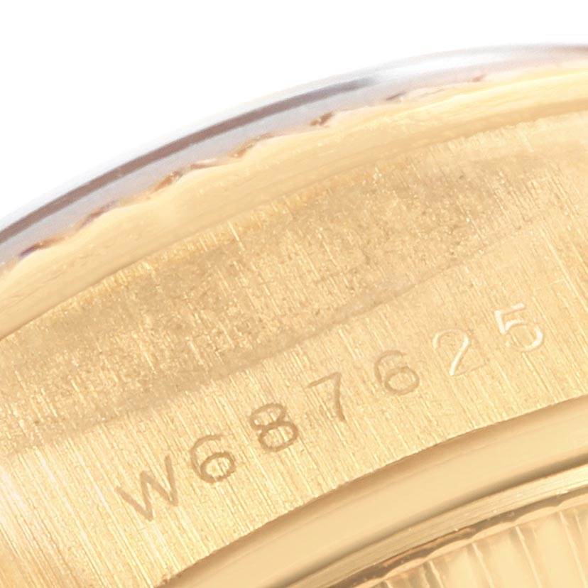 This image shows a close-up of the engraved serial number on the gold case back of a Rolex President 69178 Women's Yellow Gold White Dial 69178 Women's Yellow Gold White Dial model watch.
