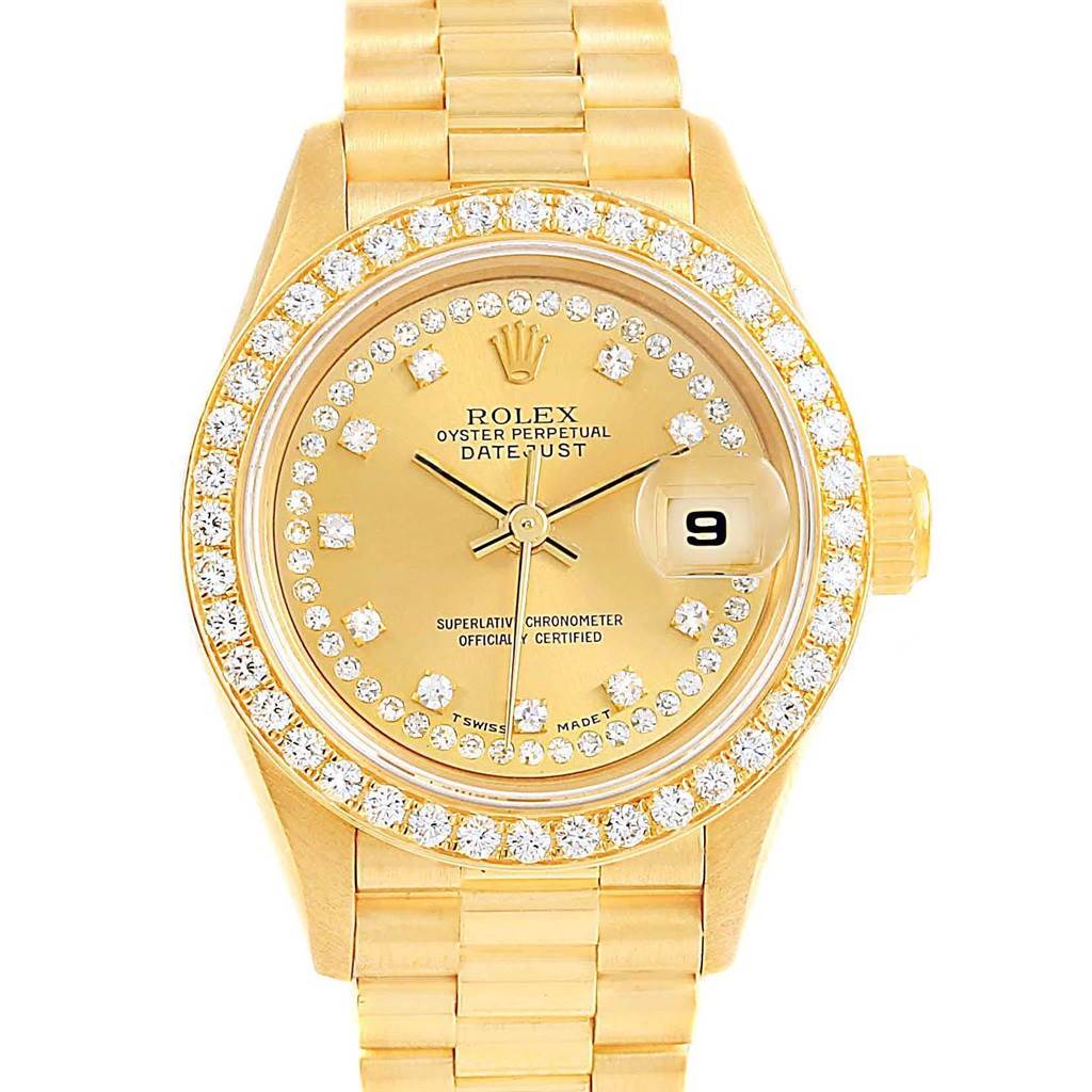 The image shows a front view of a gold Rolex President 69138 Women's Yellow Gold Champagne Dial 69138 Women's Yellow Gold Champagne Dial model watch with a diamond-encrusted bezel and gold bracelet.