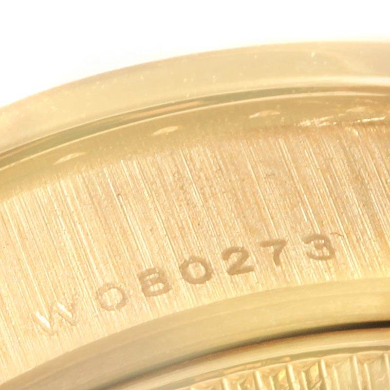 This close-up image shows a partial serial number engraving on the case back rim of a Rolex President 69138 Women's Yellow Gold Champagne Dial 69138 Women's Yellow Gold Champagne Dial model watch.
