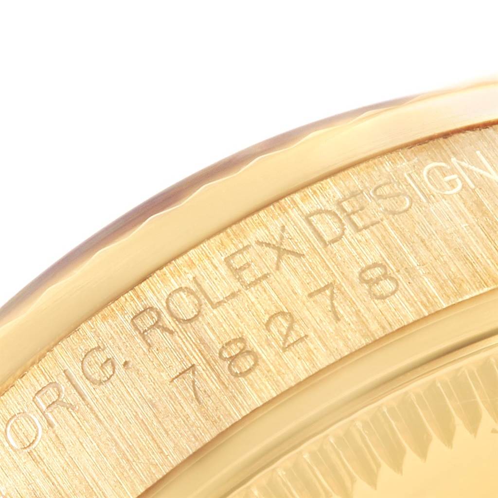 This close-up shows the engraved serial number on the bezel of a Rolex President 78278 Women
s Yellow Gold White Dial 78278 Women
s Yellow Gold White Dial model watch.