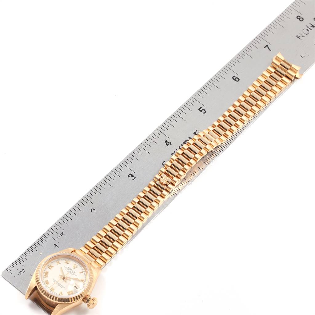 The image shows a Rolex President 69178 Women's Yellow Gold Beige Dial 69178 Women's Yellow Gold Beige Dial model watch laid flat with a connected bracelet band alongside a ruler for measurement.