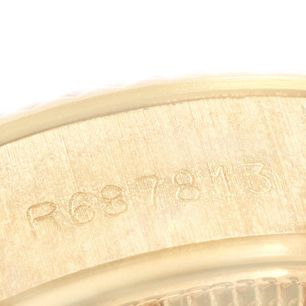 This image shows a close-up of the outer bezel and serial number engraving on a Rolex President 69178 Women's Yellow Gold Beige Dial 69178 Women's Yellow Gold Beige Dial model watch.
