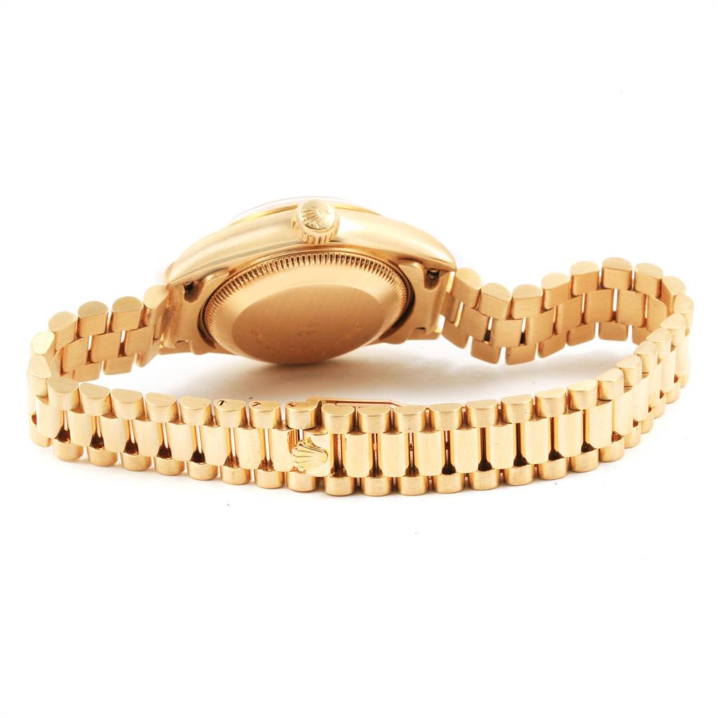 The image shows the back case and bracelet of a Rolex President 69178 Women's Yellow Gold Beige Dial 69178 Women's Yellow Gold Beige Dial model watch from a low angle.