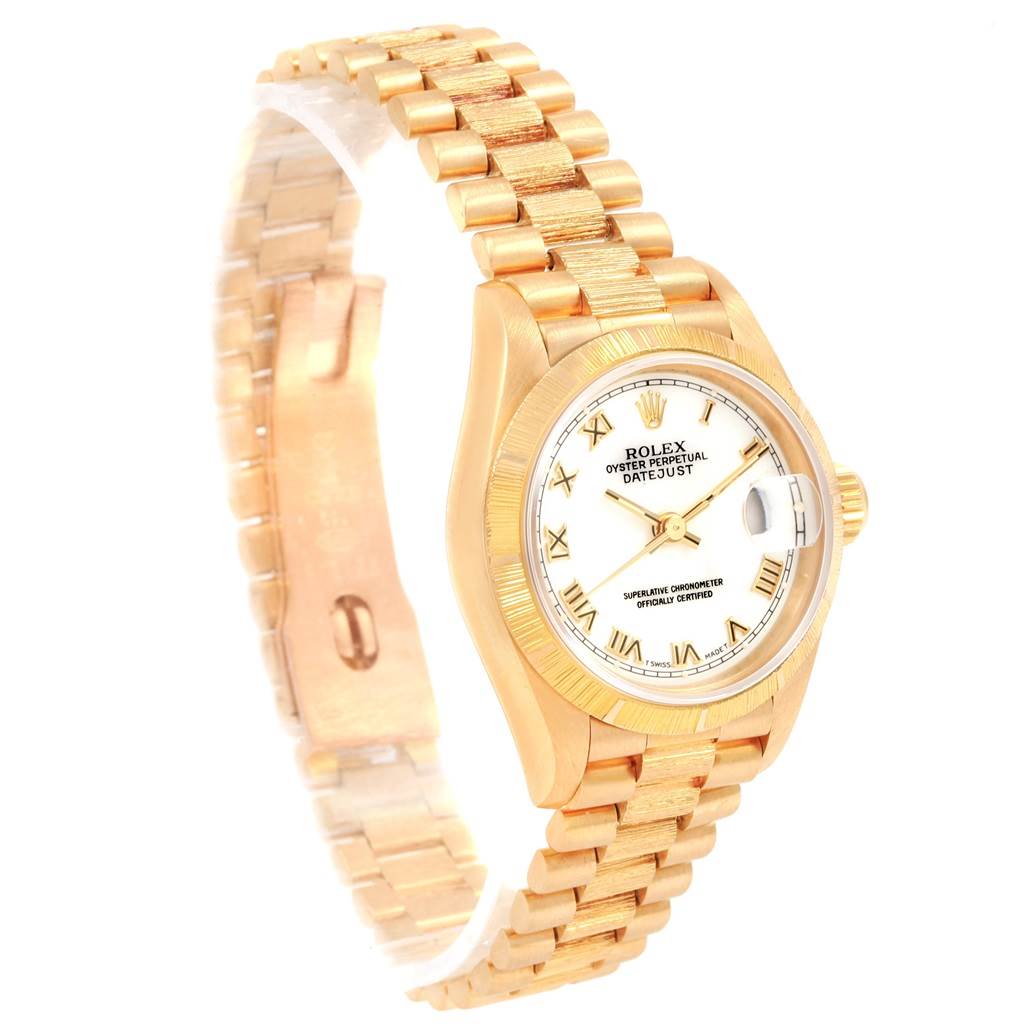 The image shows a gold Rolex President 69278 Women
s Yellow Gold White Dial 69278 Women
s Yellow Gold White Dial model watch at an angle, displaying its face, bezel, and bracelet.