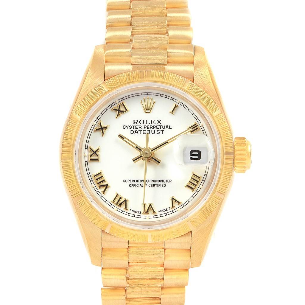 The Rolex President 69278 Women
s Yellow Gold White Dial 69278 Women
s Yellow Gold White Dial model watch is shown from a top view, displaying its gold bracelet, dial, bezel, and crown.