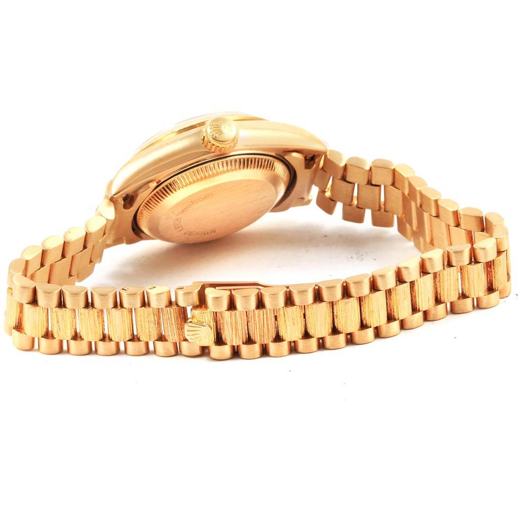 This image shows the back case and bracelet of a Rolex President 69278 Women
s Yellow Gold White Dial 69278 Women
s Yellow Gold White Dial model watch, with emphasis on the clasp and crown.