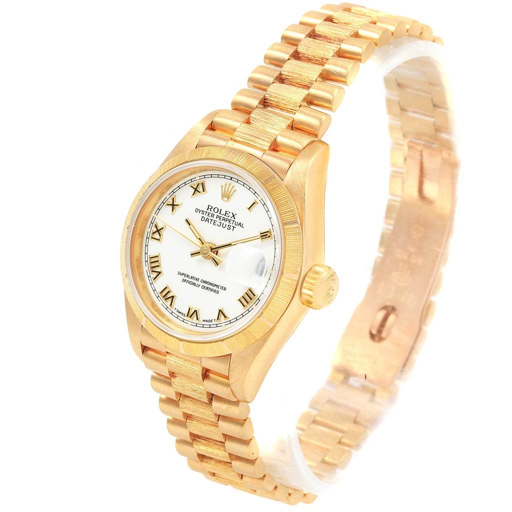 The image shows a Rolex President 69278 Women
s Yellow Gold White Dial 69278 Women
s Yellow Gold White Dial model watch at a 3/4 angle highlighting its gold case, bezel, band, and face.