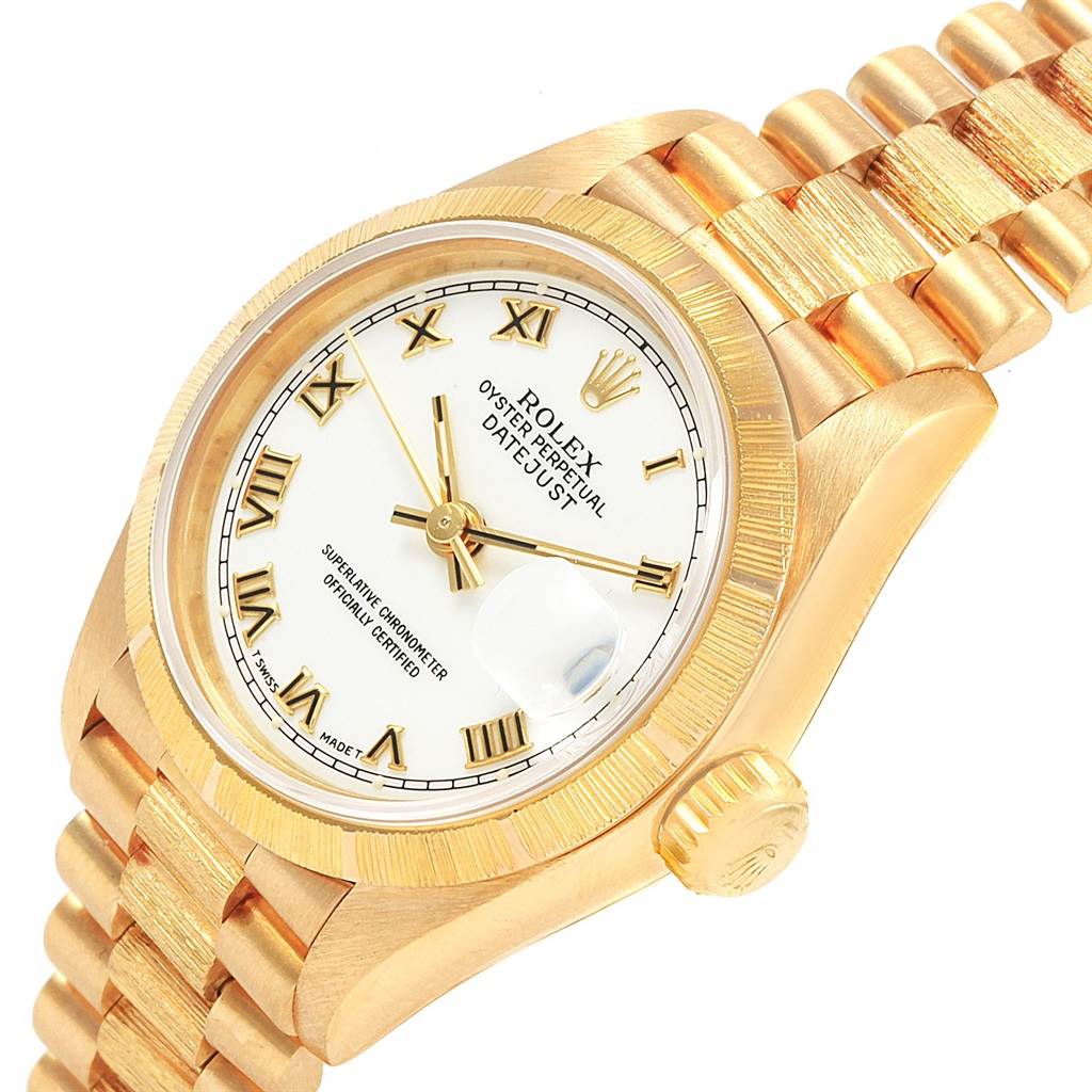 The image shows a close-up, three-quarter view of the Rolex President 69278 Women
s Yellow Gold White Dial 69278 Women
s Yellow Gold White Dial model watch, highlighting the face, bezel, crown, and part of the bracelet.