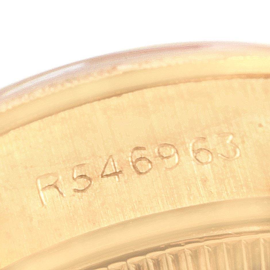 This image shows a close-up view of the engraved serial number on the Rolex President 69278 Women
s Yellow Gold White Dial 69278 Women
s Yellow Gold White Dial model watch.