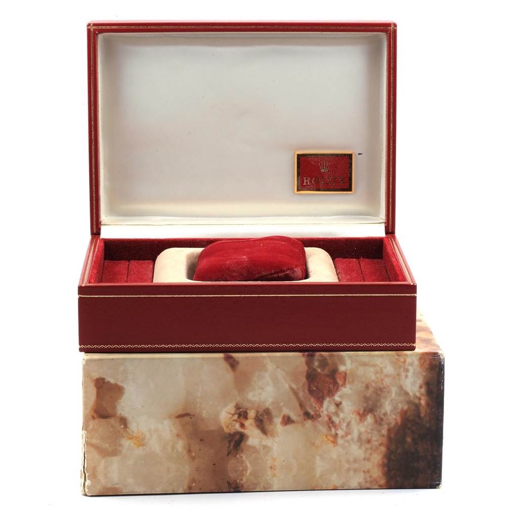 The image shows an open luxury display box for a Rolex President 69278 Women
s Yellow Gold White Dial 69278 Women
s Yellow Gold White Dial model watch, with a red cushion and marble-patterned outer box.