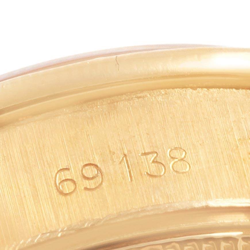 This close-up image shows part of the case back with the serial number engraving of the Rolex President 69138 Women
s Yellow Gold Black Dial 69138 Women
s Yellow Gold Black Dial model watch.