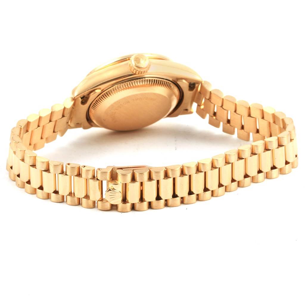 The image shows the back and side of the Rolex President 79088 Women
s Yellow Gold Champagne Dial 79088 Women
s Yellow Gold Champagne Dial watch, highlighting its gold case and bracelet from an oblique angle.