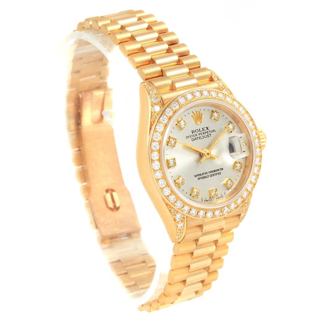 This image shows a Rolex President 69238 Women's Yellow Gold Silver Dial 69238 Women's Yellow Gold Silver Dial watch model, displaying its gold bracelet, diamond bezel, and face from a slight angle above and to the side.