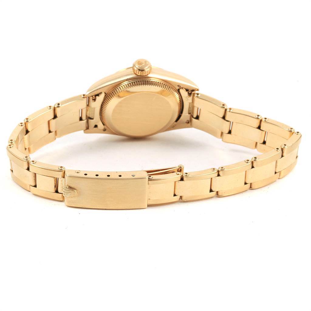 The image shows the backside and clasp of a Rolex President 67197 Women's Yellow Gold Silver Dial 67197 Women's Yellow Gold Silver Dial model watch, highlighting the bracelet and caseback.