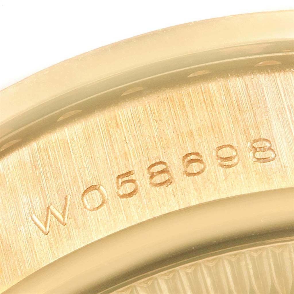 This image shows a close-up of the serial number engraved on the case back edge of a Rolex President 69158 Women
s Yellow Gold Mother of Pearl Dial 69158 Women
s Yellow Gold Mother of Pearl Dial model watch.