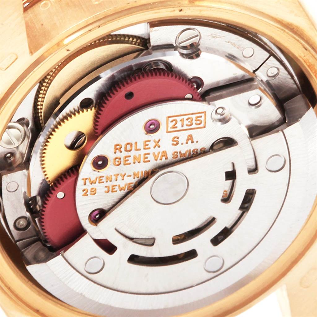 The image shows the internal mechanism of a Rolex President 69158 Women
s Yellow Gold Mother of Pearl Dial 69158 Women
s Yellow Gold Mother of Pearl Dial model watch at a close-up angle, focusing on the movement with visible gear parts.