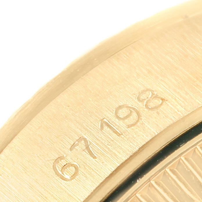 The image shows a close-up of the engraved serial number on the side of a Rolex President 67198 Women's Yellow Gold Champagne Dial 67198 Women's Yellow Gold Champagne Dial model watch.