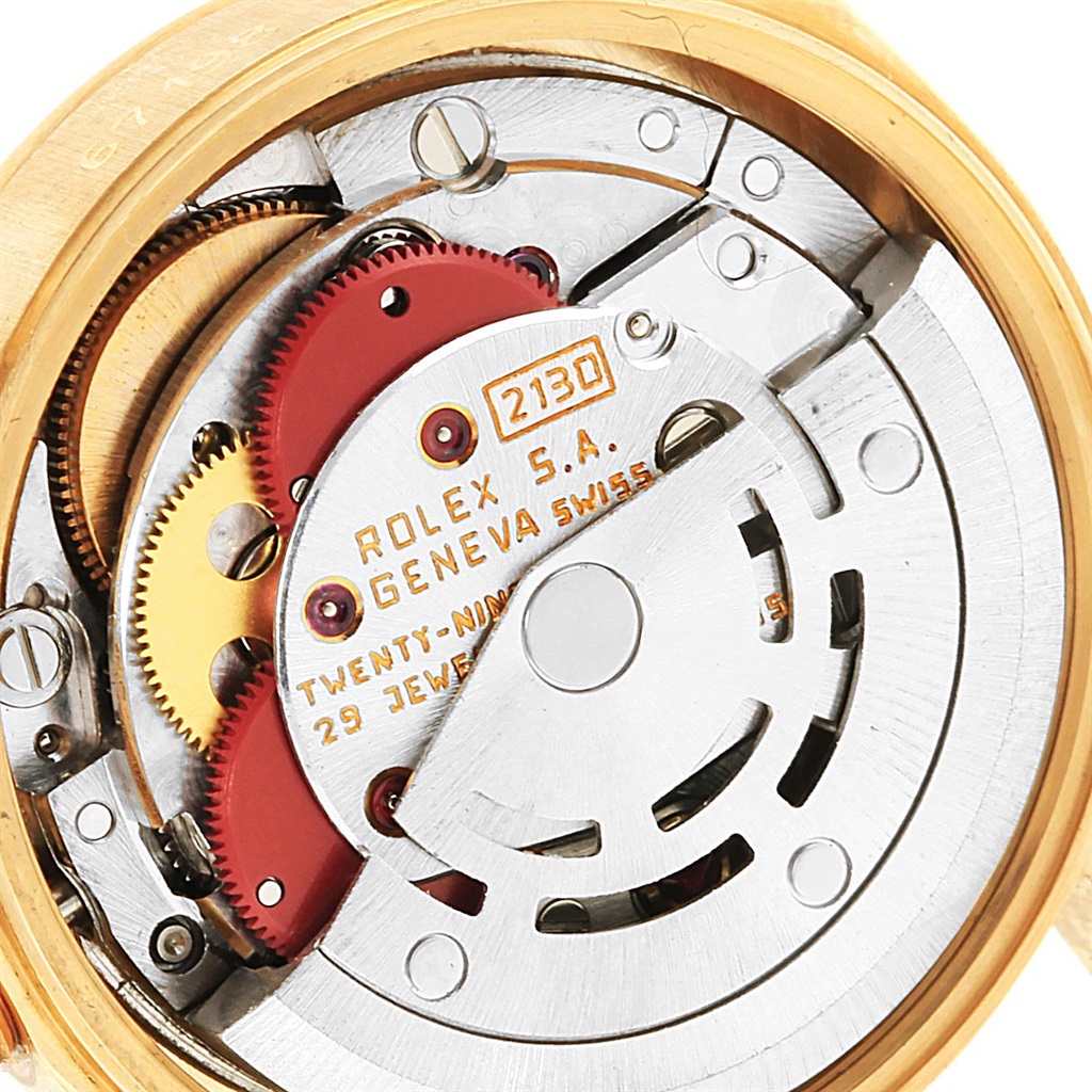 The image shows the internal mechanical movement parts of a Rolex President 67198 Women's Yellow Gold Champagne Dial 67198 Women's Yellow Gold Champagne Dial model watch, including gears and the rotor.