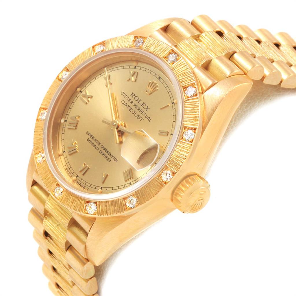 This image shows a Rolex President 69288 Women
s Yellow Gold Champagne Dial 69288 Women
s Yellow Gold Champagne Dial Datejust from an angled view, detailing its gold bezel, bracelet, crown, and date magnifier.