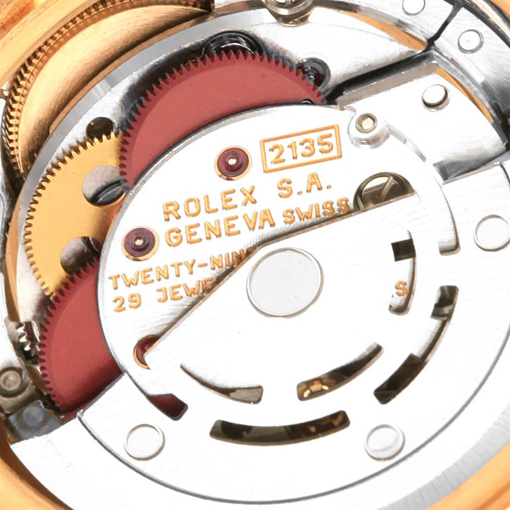 This close-up image shows the internal movement mechanism of a Rolex President 69178 Women's Yellow Gold Champagne Dial 69178 Women's Yellow Gold Champagne Dial model, highlighting the gears and inscriptions.