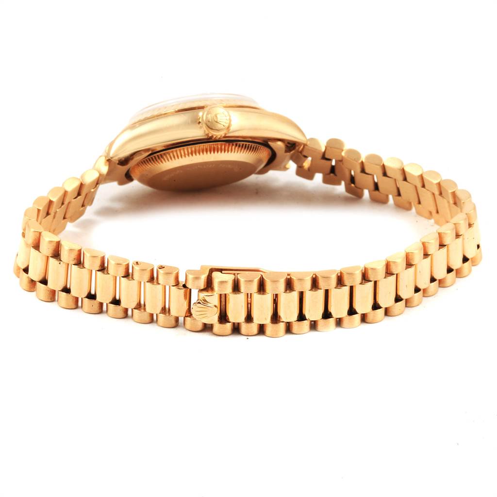 The image shows a side angle of a Rolex President 69178 Women
s Yellow Gold Champagne Dial 69178 Women
s Yellow Gold Champagne Dial model watch focusing on the bracelet and case back.